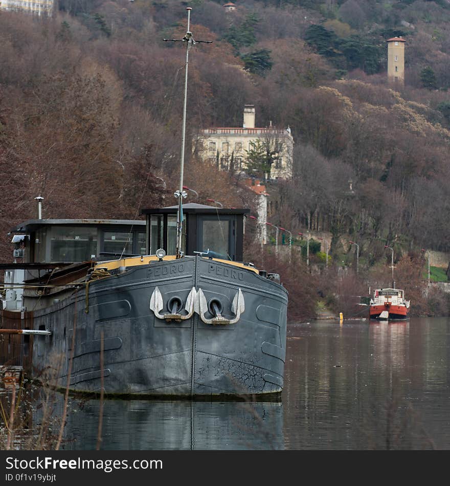 Metal hulled ship moored to waterfront. Metal hulled ship moored to waterfront.