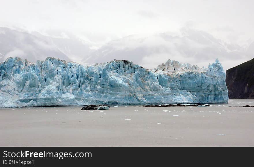 Hubbard Glacier is a glacier located in eastern Alaska and part of Yukon Canada. Map of Hubbard Glacier Hubbard Glacier, Alaska squeezes towards Gilbert Point on May 20, 2002 The glacier is close to sealing off Russell Fjord at top from Disenchantment Bay at bottom. The longest source for Hubbard Glacier originates 122 kilometres &#x28;76 mi&#x29; from its snout and is located at about 61°00′N 140°09′W, approximately 8 kilometres &#x28;5 mi&#x29; west of Mount Walsh with an altitude around 11,000 feet &#x28;3,400 m&#x29;. A shorter tributary glacier begins at the easternmost summit on the Mount Logan ridge at about 18,300 feet &#x28;5,600 m&#x29; at about 60°35′0″N 140°22′40″W. Before it reaches the sea, Hubbard is joined by the Valerie Glacier to the west, which, through forward surges of its own ice, has contributed to the advance of the ice flow that experts believe will eventually dam the Russell Fjord from Disenchantment Bay waters. Hubbard Glacier is a glacier located in eastern Alaska and part of Yukon Canada. Map of Hubbard Glacier Hubbard Glacier, Alaska squeezes towards Gilbert Point on May 20, 2002 The glacier is close to sealing off Russell Fjord at top from Disenchantment Bay at bottom. The longest source for Hubbard Glacier originates 122 kilometres &#x28;76 mi&#x29; from its snout and is located at about 61°00′N 140°09′W, approximately 8 kilometres &#x28;5 mi&#x29; west of Mount Walsh with an altitude around 11,000 feet &#x28;3,400 m&#x29;. A shorter tributary glacier begins at the easternmost summit on the Mount Logan ridge at about 18,300 feet &#x28;5,600 m&#x29; at about 60°35′0″N 140°22′40″W. Before it reaches the sea, Hubbard is joined by the Valerie Glacier to the west, which, through forward surges of its own ice, has contributed to the advance of the ice flow that experts believe will eventually dam the Russell Fjord from Disenchantment Bay waters.