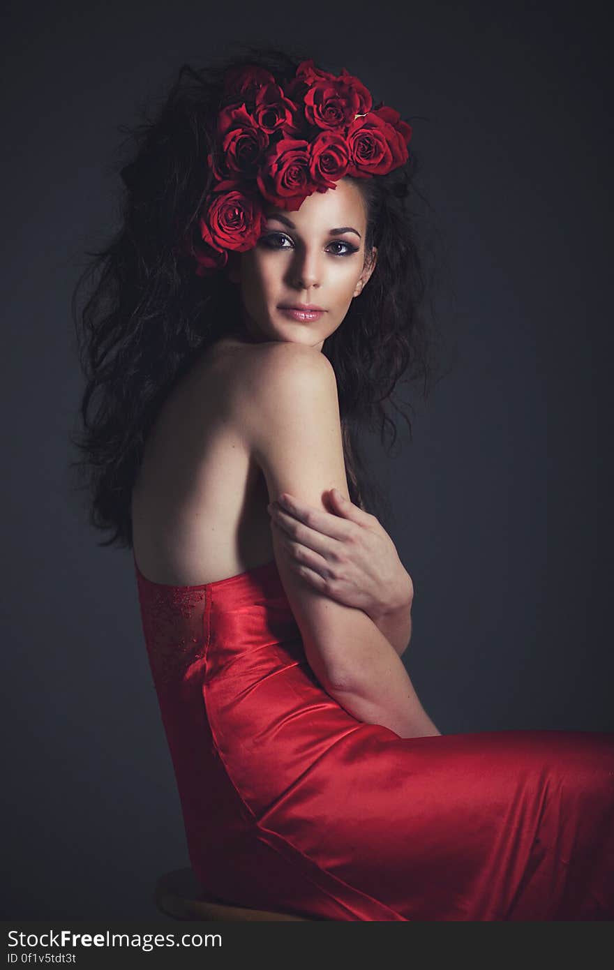 Fashion studio portrait of woman in red dress and hat. Fashion studio portrait of woman in red dress and hat.