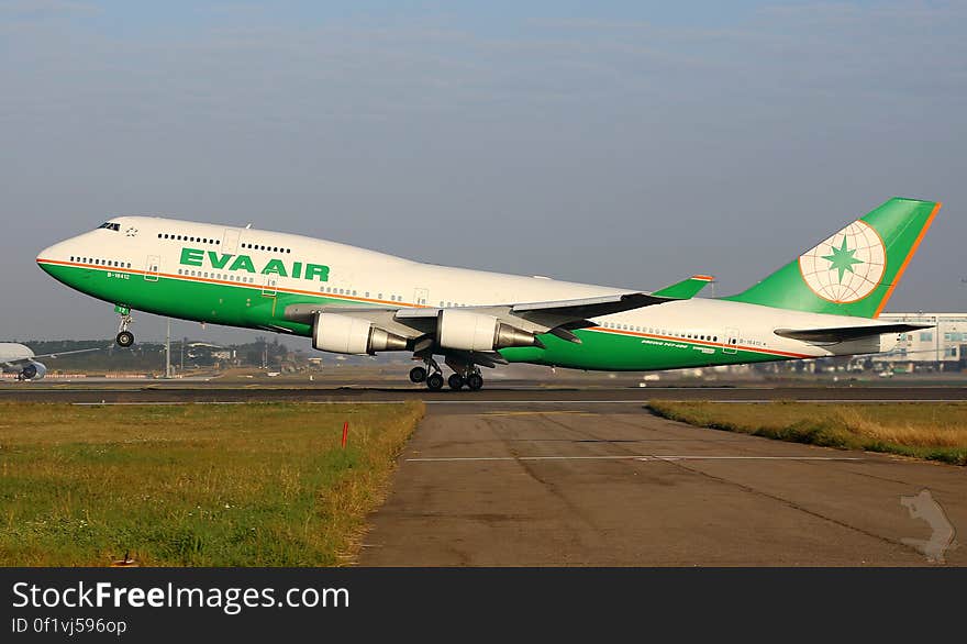 Eva Air airliner on runway at take-off on sunny day. Eva Air airliner on runway at take-off on sunny day.