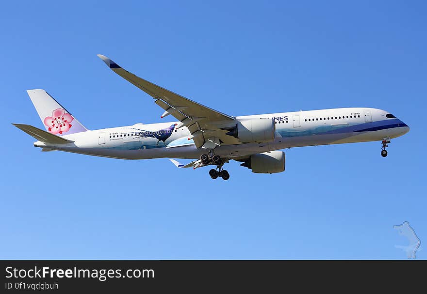 Commercial airliner flying against blue skies on sunny day. Commercial airliner flying against blue skies on sunny day.