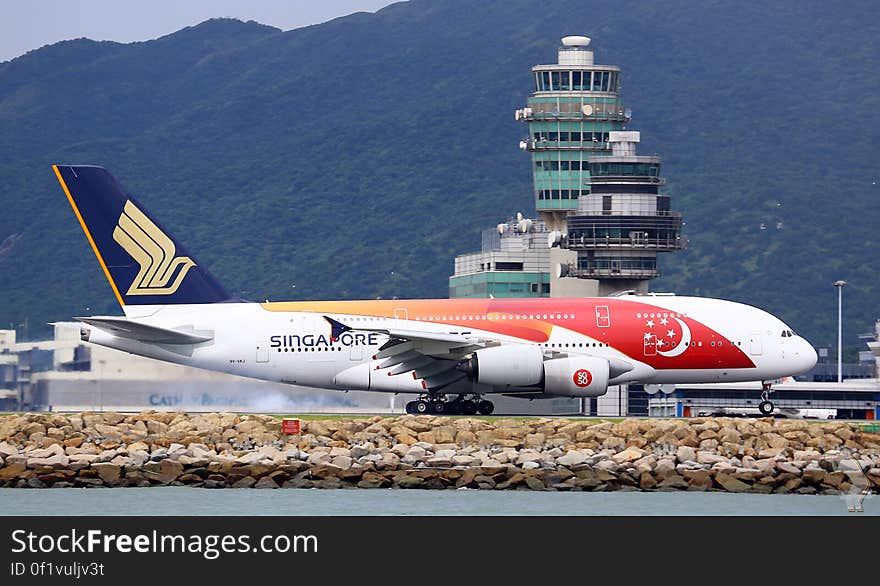 Singapore Airline plane on runway on sunny day. Singapore Airline plane on runway on sunny day.