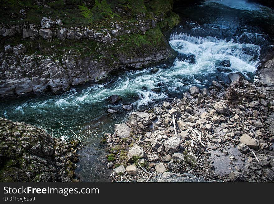 Elevated view of fast flowing river and waterfall in rocky gorge.