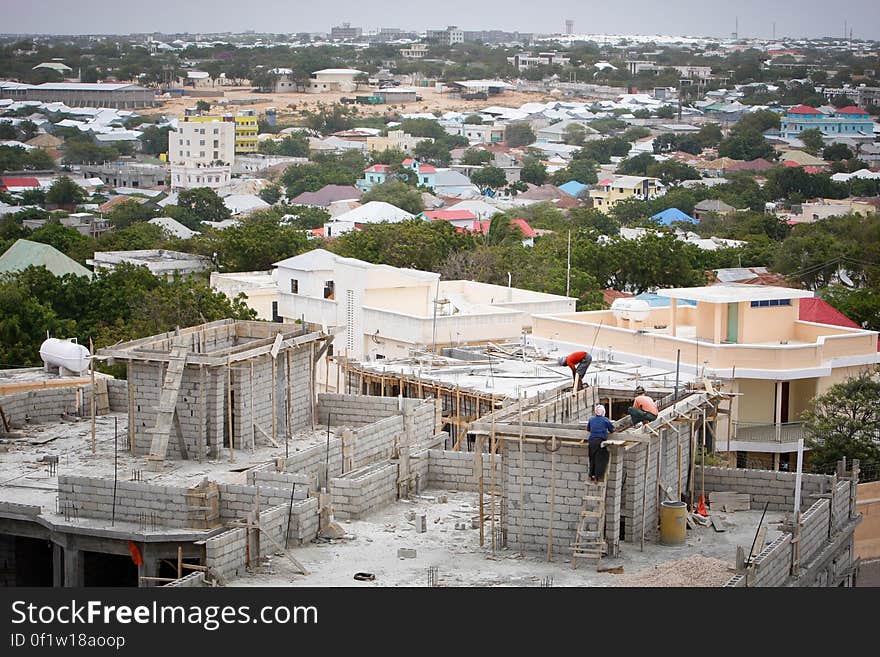 Construction workers work on a building in the Medina district of the Somali capital Mogadishu, 05 August, 2013. 06 August marks 2 years since the Al Qaeda-affiliated extremist group Al Shabaab withdrew from Mogadishu following sustained operations by forces of the Somali National Army &#x28;SNA&#x29; backed by troops of the African Union Mission in Somalia &#x28;AMISOM&#x29; to retake the city. Since the group&#x27;s departure the country&#x27;s captial has re-established itself and a sense of normality has returned. Buildings and infrastructure devastated and destroyed by two decades of conflict have been repaired; thousands of Diaspora Somalis have returned home to invest and help rebuild their nation; foreign embassies and diplomatic missions have reopened and for the first time in many years, Somalia has an internationally recognised government.. AU-UN IST PHOTO / STUART PRICE. Construction workers work on a building in the Medina district of the Somali capital Mogadishu, 05 August, 2013. 06 August marks 2 years since the Al Qaeda-affiliated extremist group Al Shabaab withdrew from Mogadishu following sustained operations by forces of the Somali National Army &#x28;SNA&#x29; backed by troops of the African Union Mission in Somalia &#x28;AMISOM&#x29; to retake the city. Since the group&#x27;s departure the country&#x27;s captial has re-established itself and a sense of normality has returned. Buildings and infrastructure devastated and destroyed by two decades of conflict have been repaired; thousands of Diaspora Somalis have returned home to invest and help rebuild their nation; foreign embassies and diplomatic missions have reopened and for the first time in many years, Somalia has an internationally recognised government.. AU-UN IST PHOTO / STUART PRICE.