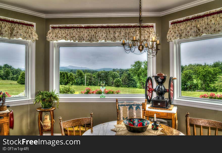 Brown Wooden Chair Near Green Leaf Plant and Window