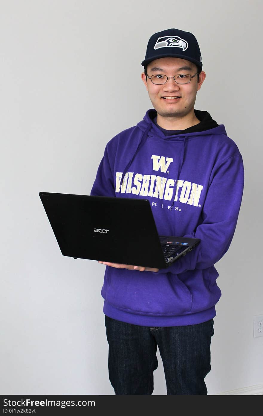 Photo of a person posing with a laptop. Photo of a person posing with a laptop.