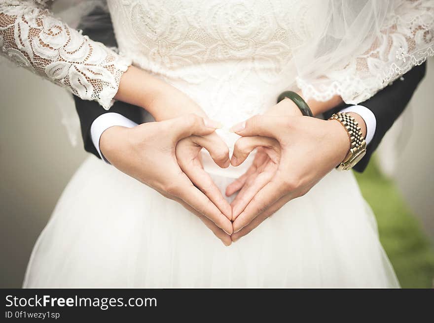 Midsection of Woman Making Heart Shape With Hands