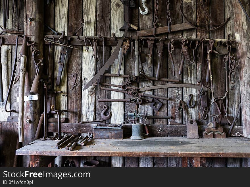 Black Metal Tools Hanged on a Rack Near Table