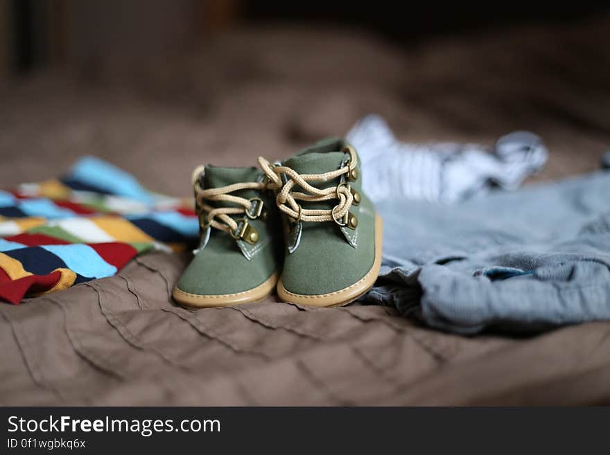 Baby&#x27;s Green and Beige Sneakers on Brown Textile