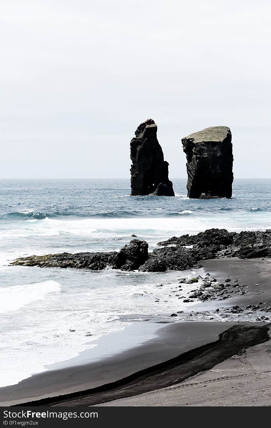 2 Black Cliff on Sea during Daytime