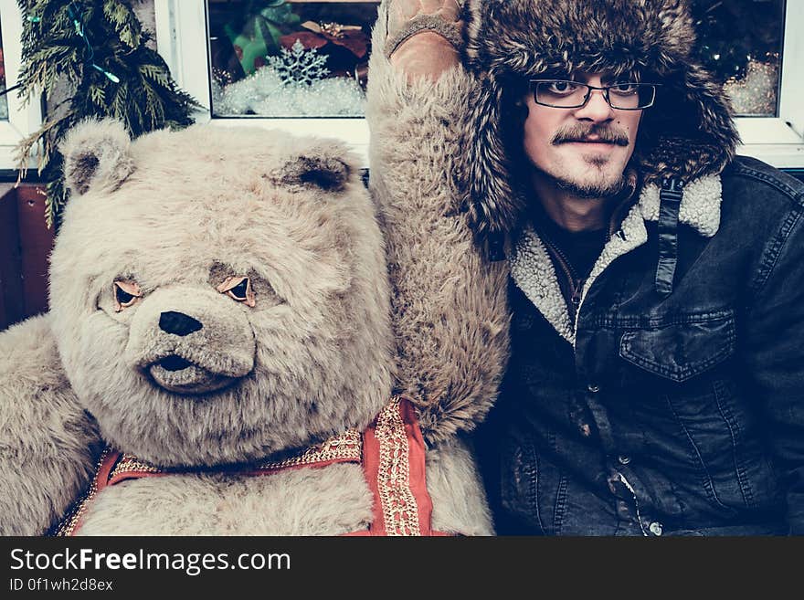 Man with a human size teddy bear. Man with a human size teddy bear.