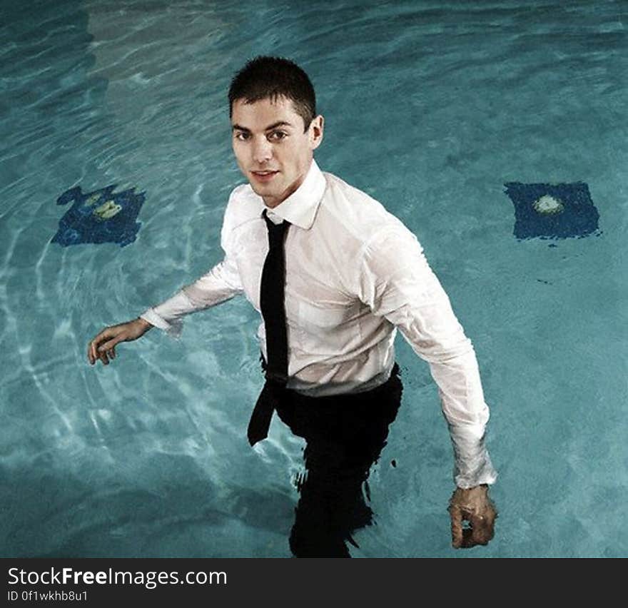 Businessman in a Swimming Pool --- Image by © Serge Kozak/zefa/Corbis. Businessman in a Swimming Pool --- Image by © Serge Kozak/zefa/Corbis