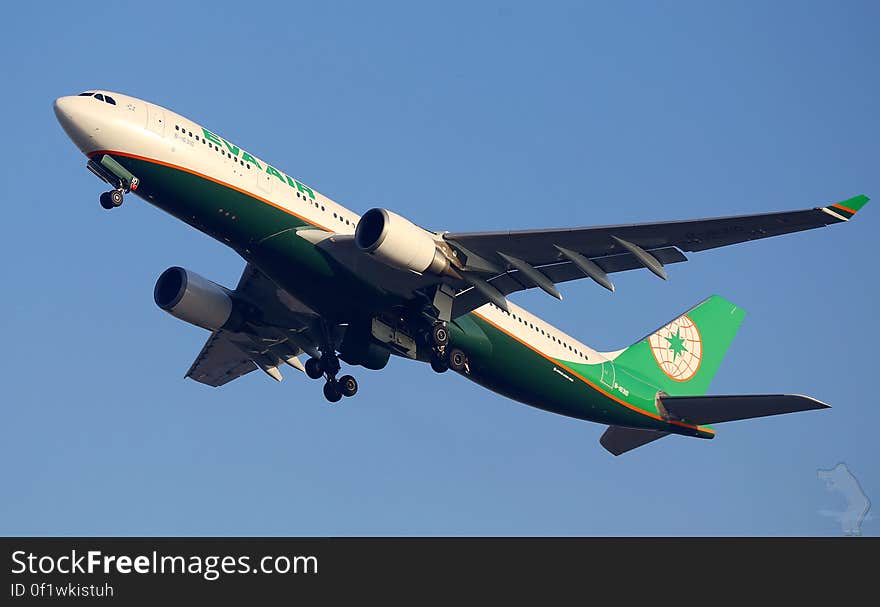 Eva Air airline plane in flight against blue skies. Eva Air airline plane in flight against blue skies.