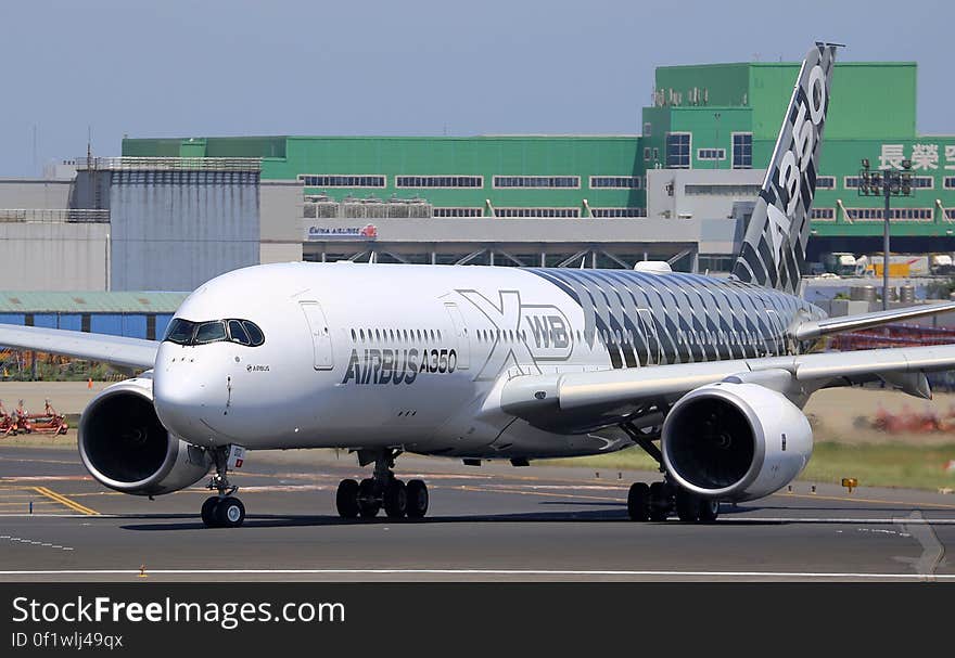 A landed Airbus A350 airplane on a runway.