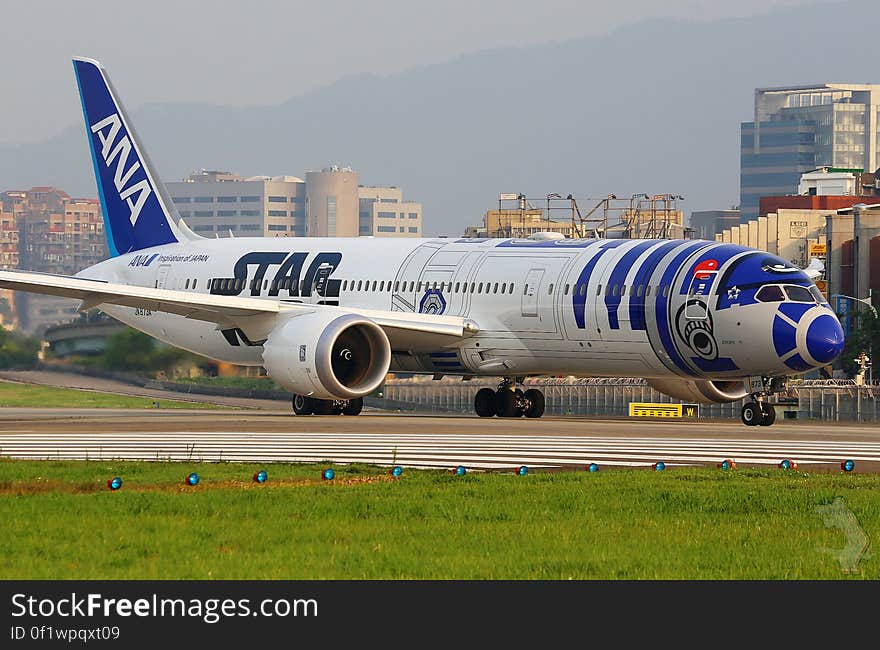 ANA airliner on runway at airport.