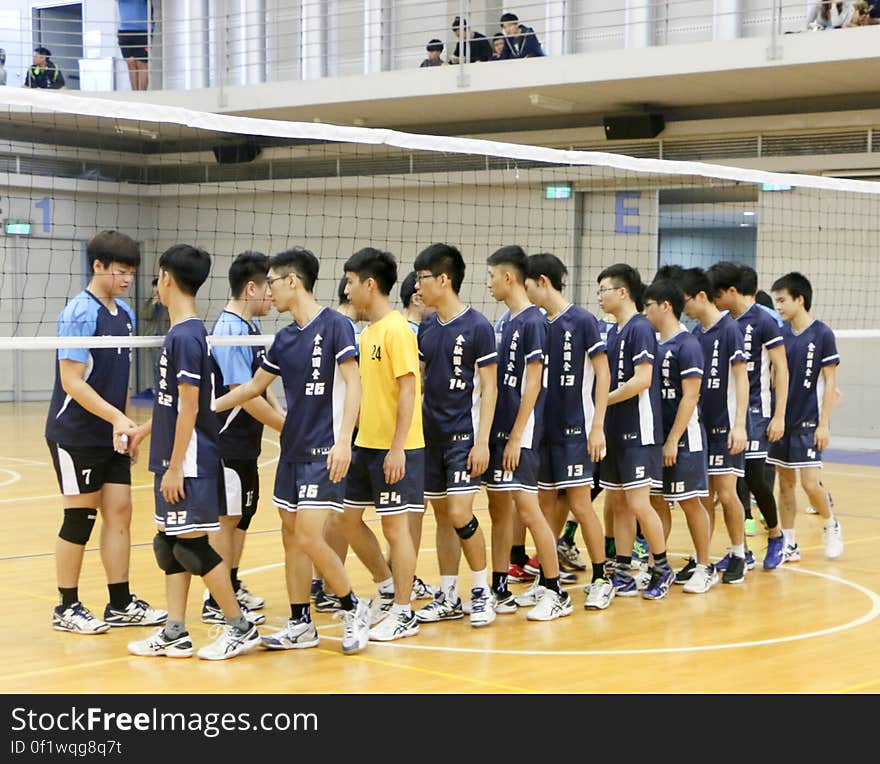 People shake hands after a volleyball game to show good sportsmanship.