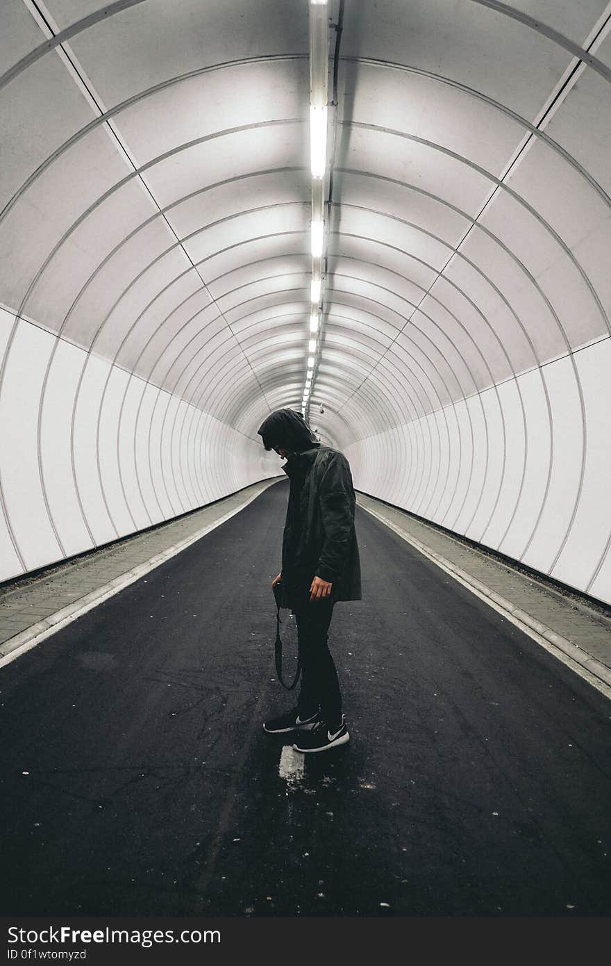 Man in Black Hoodie Standing Inside Panel