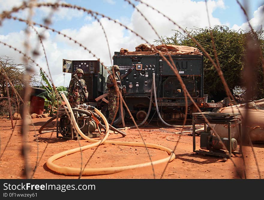 SOMALIA, Kismayo: In a photograph taken 16 July 2013 and released by the African Union-United Nations Information Support Team 22 July, soldiers from the Kenyan Contingent serving with the African Union Mission in Somalia &#x28;AMISOM&#x29; man a water purifying unit inside a miltary base near the southern Somali port city of Kismayo. AU-UN IST PHOTO / RAMADAN MOHAMED HASSAN. SOMALIA, Kismayo: In a photograph taken 16 July 2013 and released by the African Union-United Nations Information Support Team 22 July, soldiers from the Kenyan Contingent serving with the African Union Mission in Somalia &#x28;AMISOM&#x29; man a water purifying unit inside a miltary base near the southern Somali port city of Kismayo. AU-UN IST PHOTO / RAMADAN MOHAMED HASSAN.