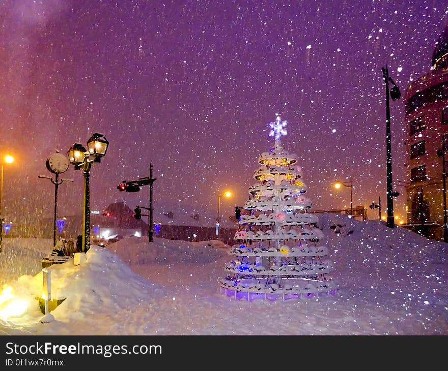 A Christmas tree made of different decorative items with a snowflake on top. A Christmas tree made of different decorative items with a snowflake on top.