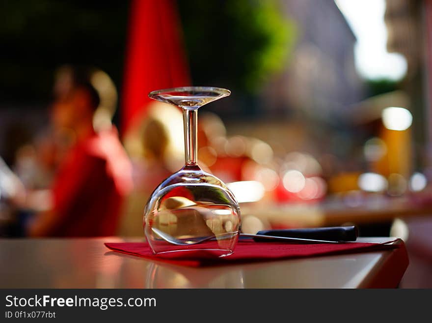 Clear Wine Glass on Top of Brown Table