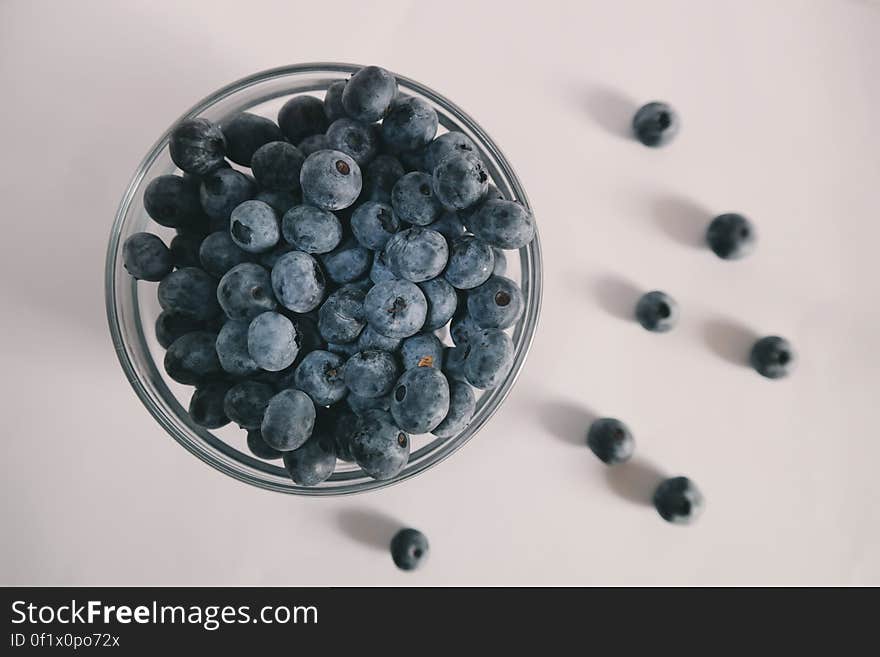 A glass bowl with blueberries. A glass bowl with blueberries.