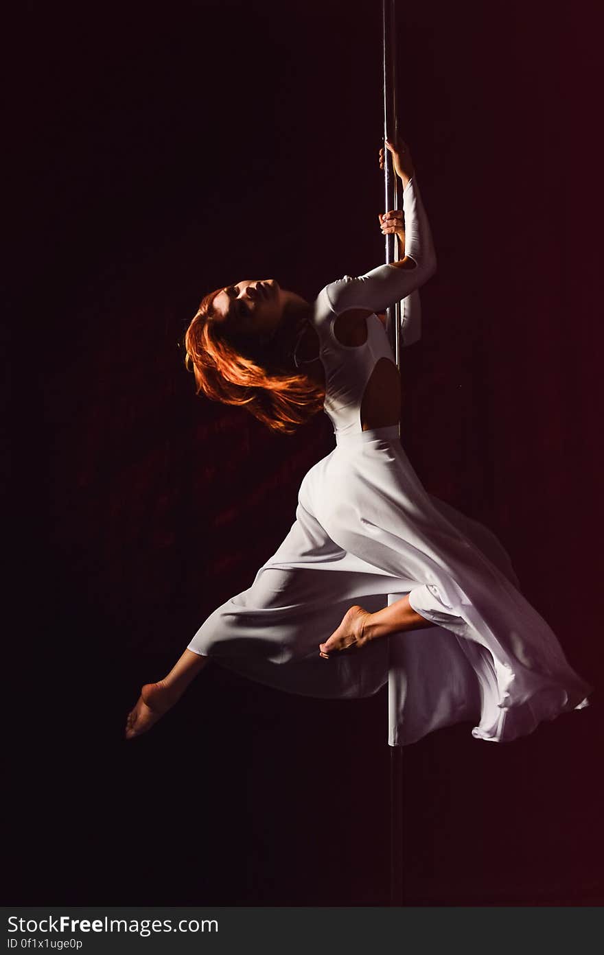 Woman in White Dress Hanging on Pole