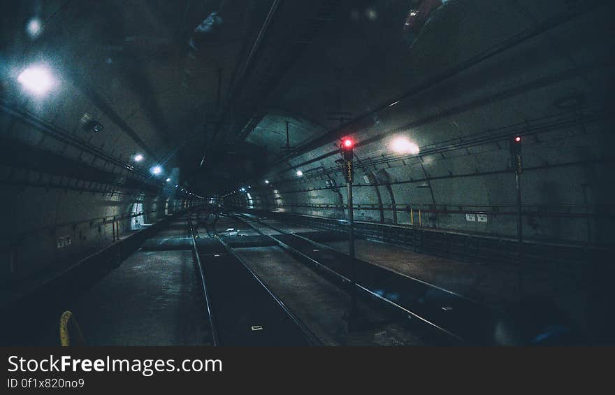 Underground railway tube tunnel receding into distance.