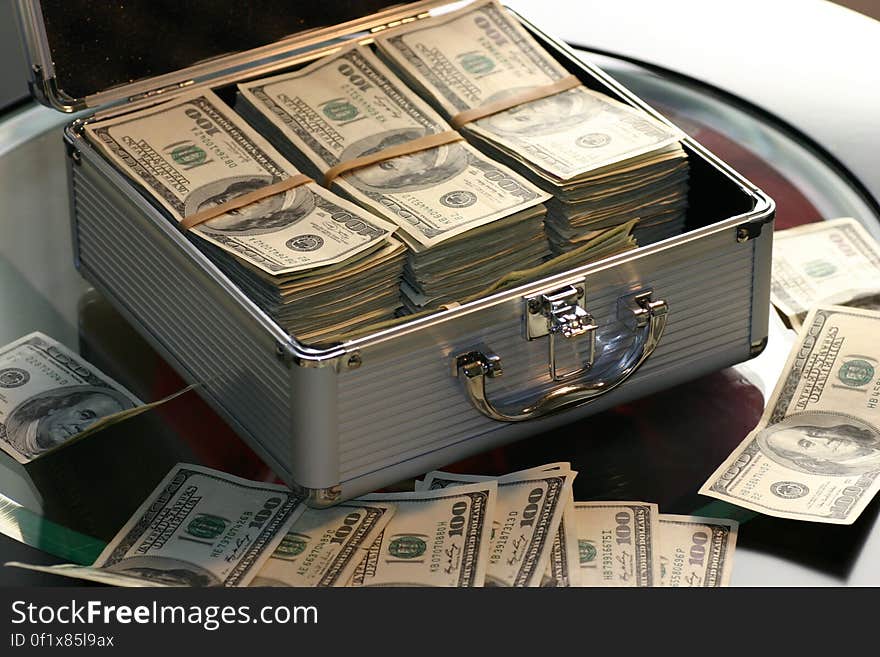 Hundred dollar bills in a metal case. Hundred dollar bills in a metal case.