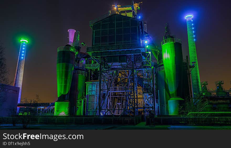 An industrial lot at night with colorful lights. An industrial lot at night with colorful lights.