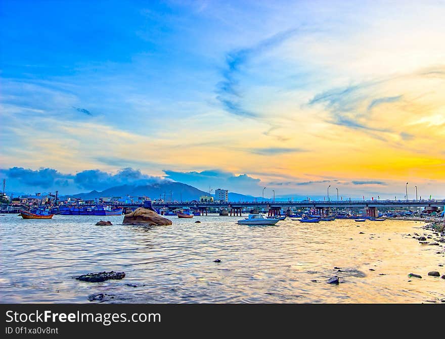 Sunset on the coast with may boats in the water. Sunset on the coast with may boats in the water.