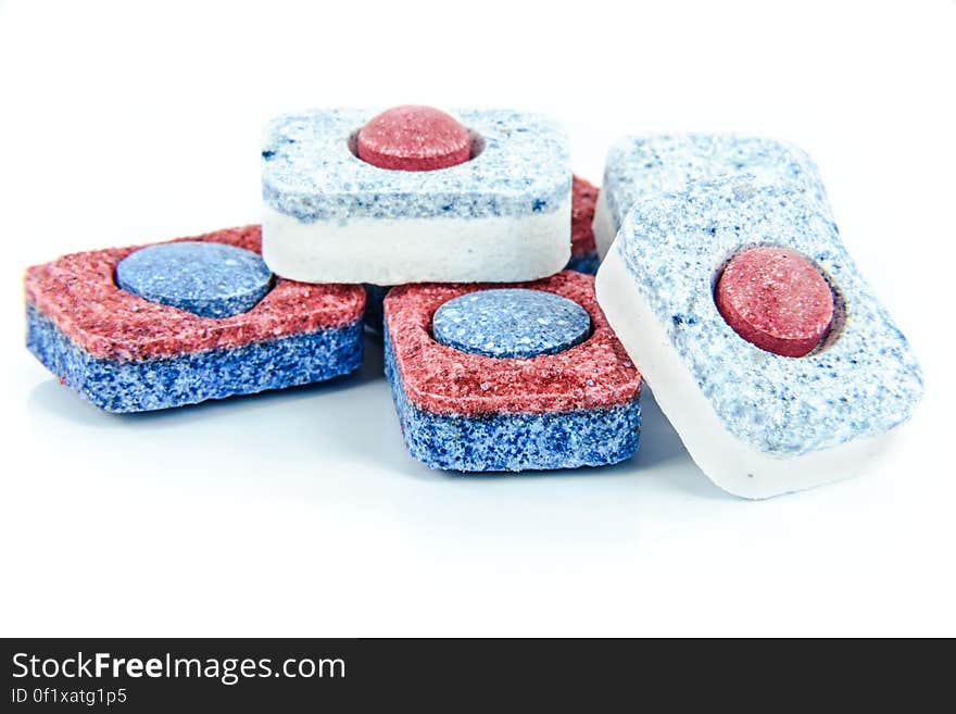 Several dishwasher detergent tablets on a white background. Several dishwasher detergent tablets on a white background.