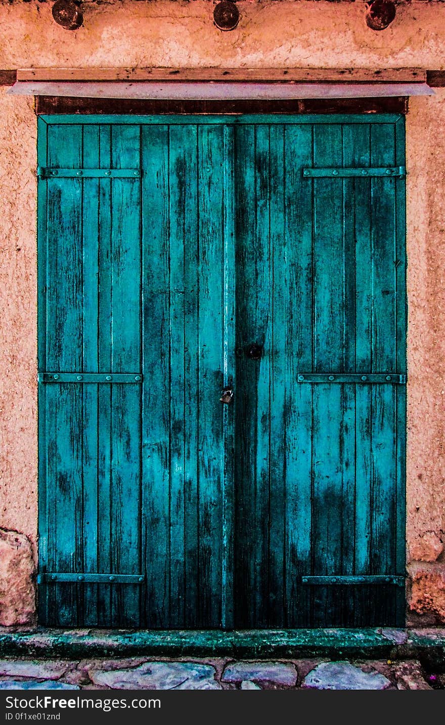 An old blue wooden entrance door. An old blue wooden entrance door.