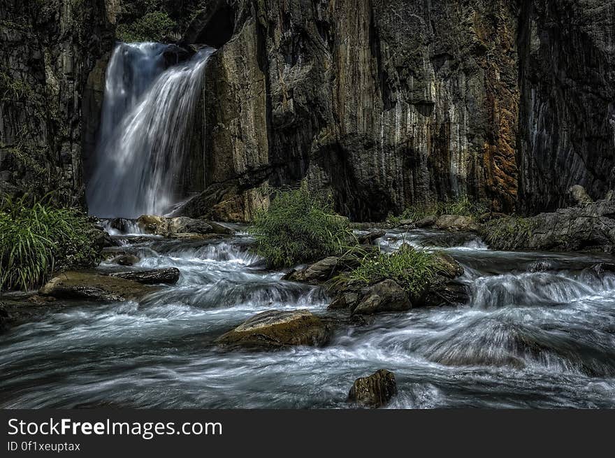 A waterfall and a cascading creek in a forest. A waterfall and a cascading creek in a forest.