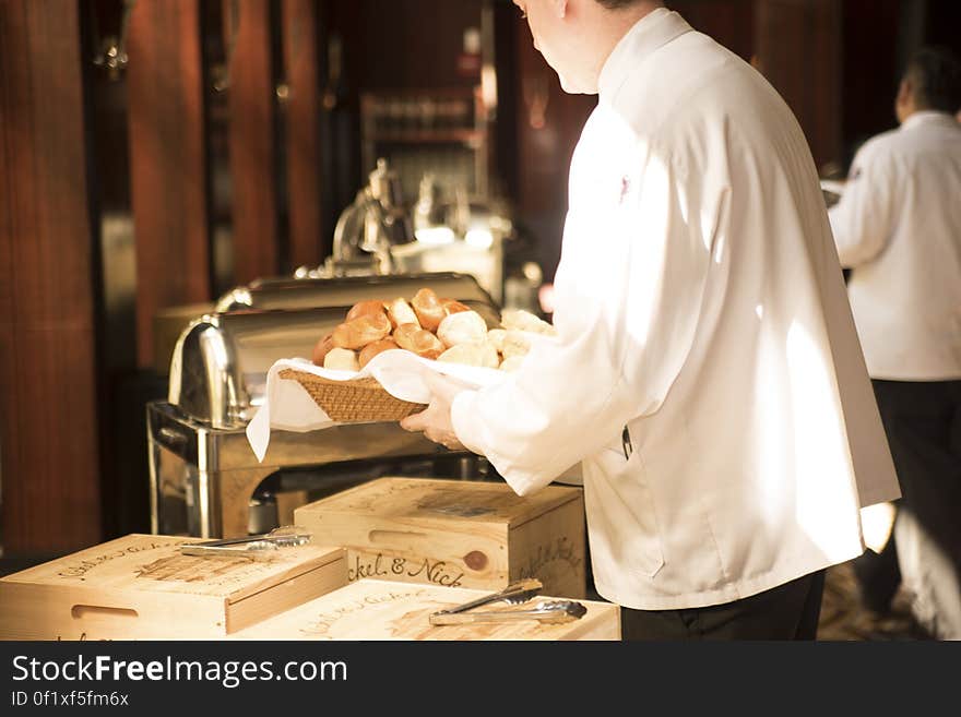 Restaurant workers restocking the buffet tables. Restaurant workers restocking the buffet tables.