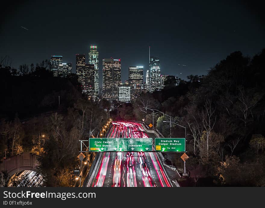 A view of the city of Los Angeles with the interstate 110 full of cars at night. A view of the city of Los Angeles with the interstate 110 full of cars at night.