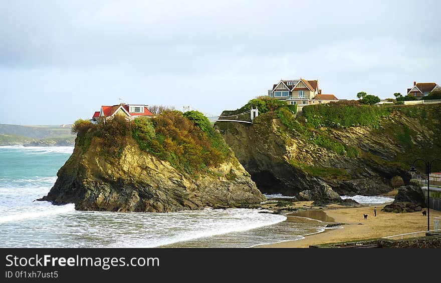 A rocky coast with houses on top of the rocks. A rocky coast with houses on top of the rocks.