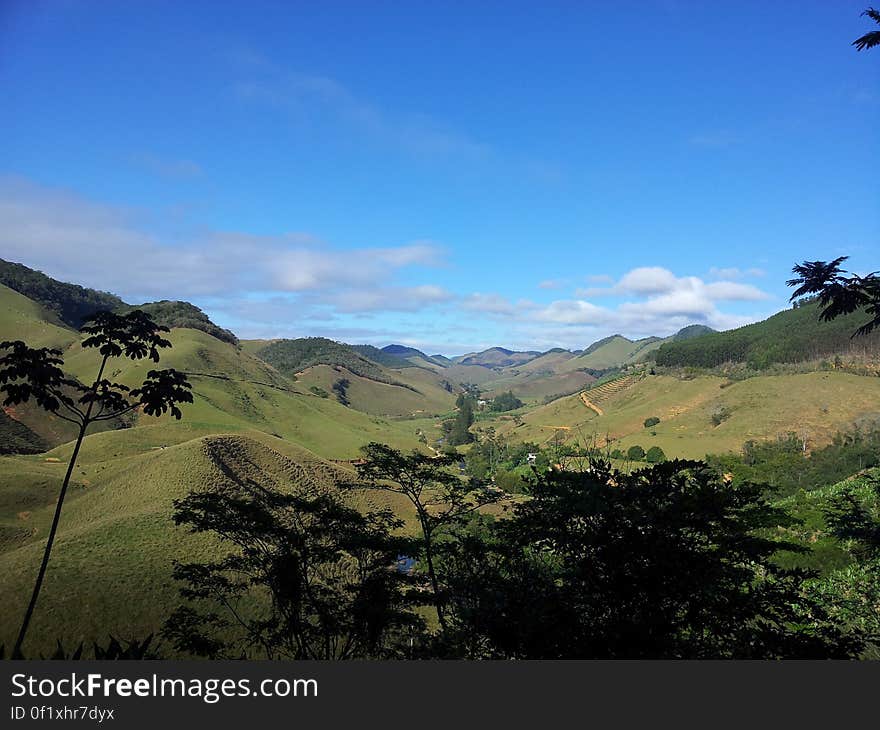 Picturesque landscape of green valley with blue sky background. Picturesque landscape of green valley with blue sky background.