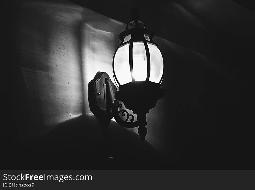 Monochrome view of illuminated vintage style light at night.