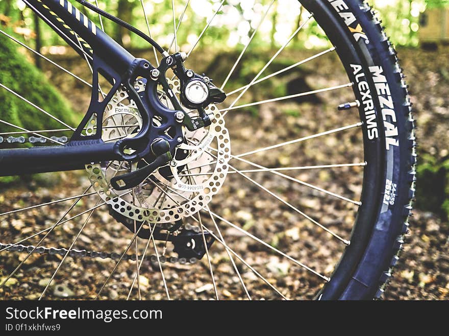 A close up shot of a bicycle back wheel outdoor.