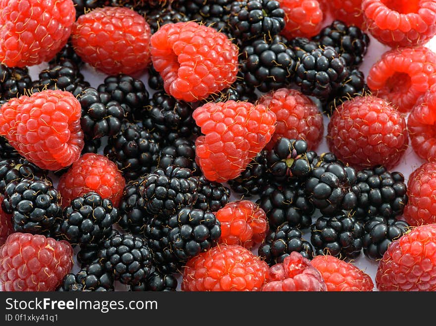 Textured background of fresh fruits created with closeup of Blackberries and Raspberries. Textured background of fresh fruits created with closeup of Blackberries and Raspberries.