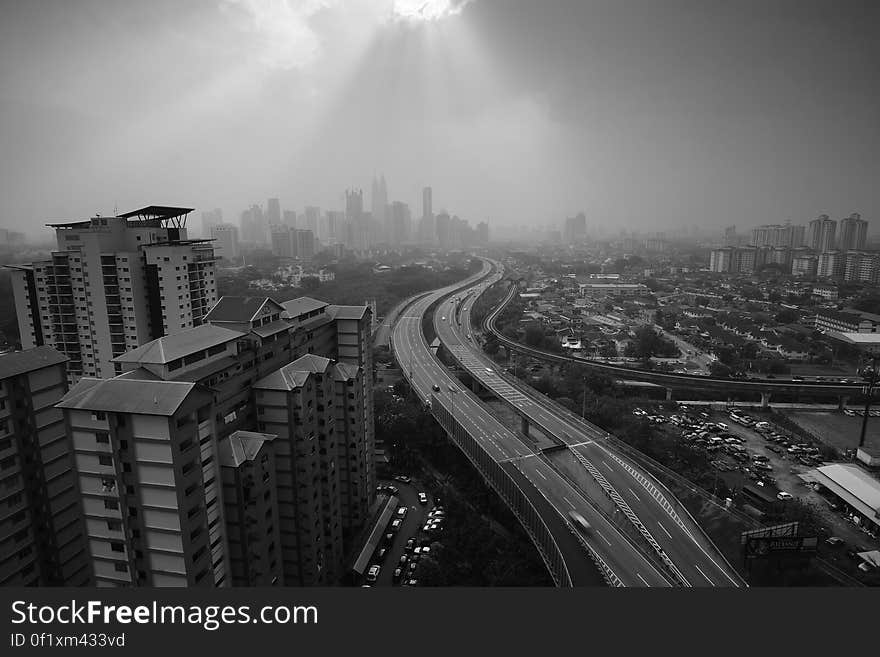 A black and white panoramic view of a highway through a city. A black and white panoramic view of a highway through a city.