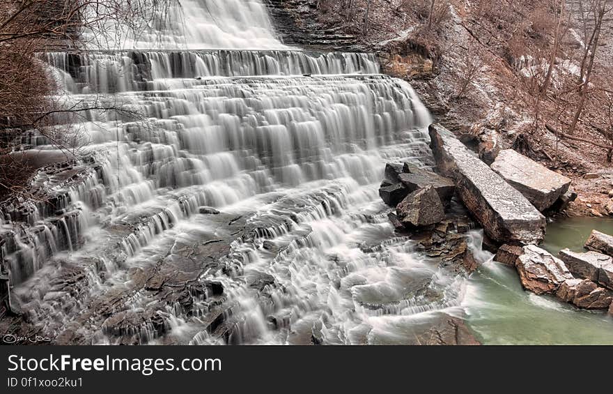 Waterfalls Flowing on Brown Rock Formation Towards River