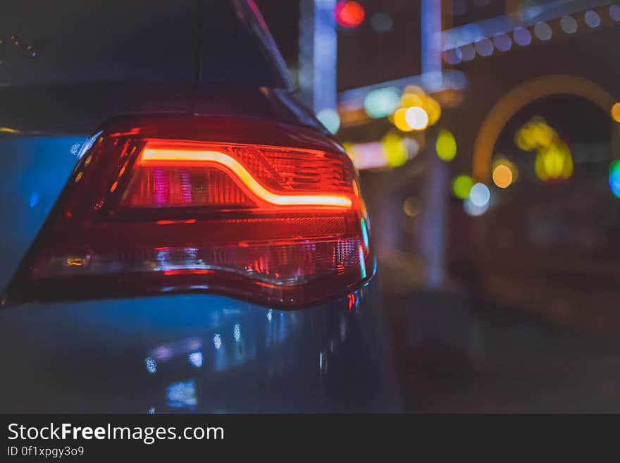 A close up of a red stop light on a car. A close up of a red stop light on a car.