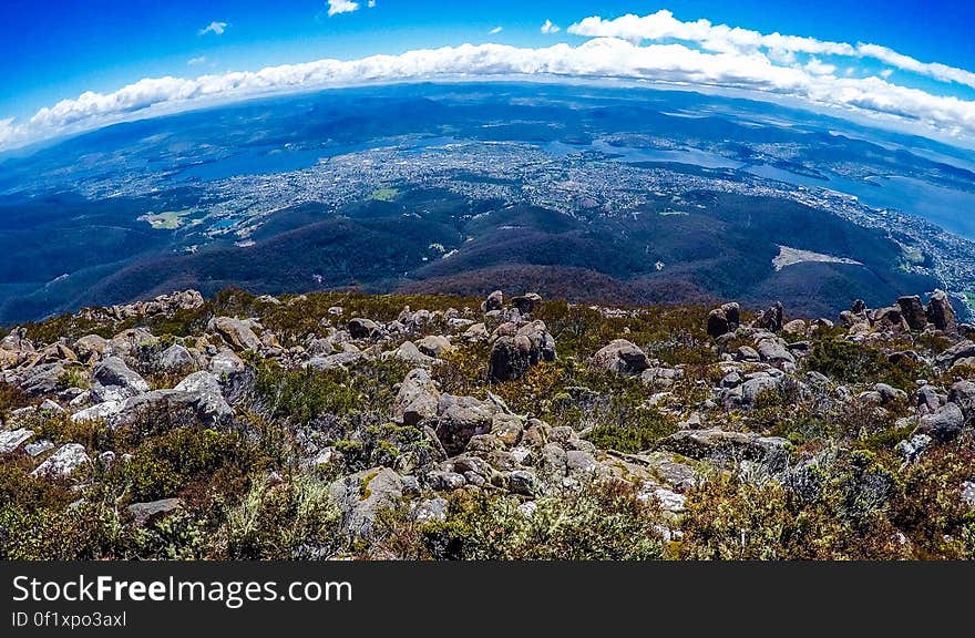 A view of the landscape from the mountain top, a town and the sea in the distance. A view of the landscape from the mountain top, a town and the sea in the distance.