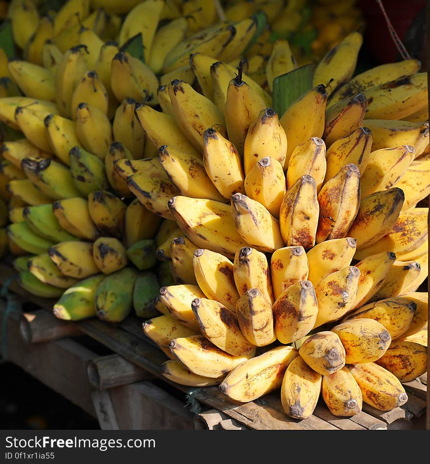 A market stall of ripe bunches of bananas. A market stall of ripe bunches of bananas.