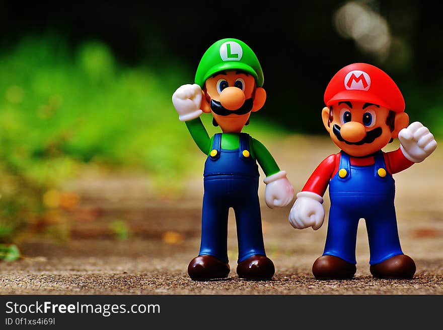 Macro Photography of Mario and Luigi Plastic Toy