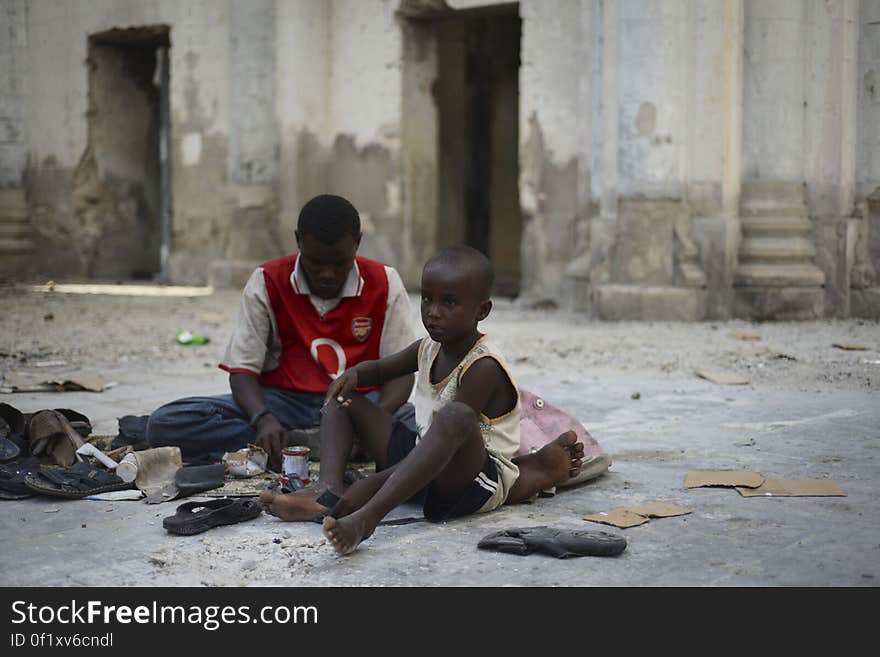 A father and his son repair shoes on the floor of Mogadishu&#x27;s old cathedral, now largely a ruin after two decades of civil war in Somalia. Although much of Mogadishu now lies in ruins, a newfound peace has meant that many of the city&#x27;s residents have been able to return to work and their normal daily lives. 18 November, 2012. AU-UN IST PHOTO / TOBIN JONES. A father and his son repair shoes on the floor of Mogadishu&#x27;s old cathedral, now largely a ruin after two decades of civil war in Somalia. Although much of Mogadishu now lies in ruins, a newfound peace has meant that many of the city&#x27;s residents have been able to return to work and their normal daily lives. 18 November, 2012. AU-UN IST PHOTO / TOBIN JONES.