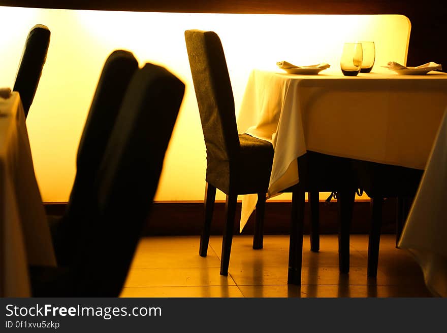 Beige Table Cloth Beside Black Padded Chair