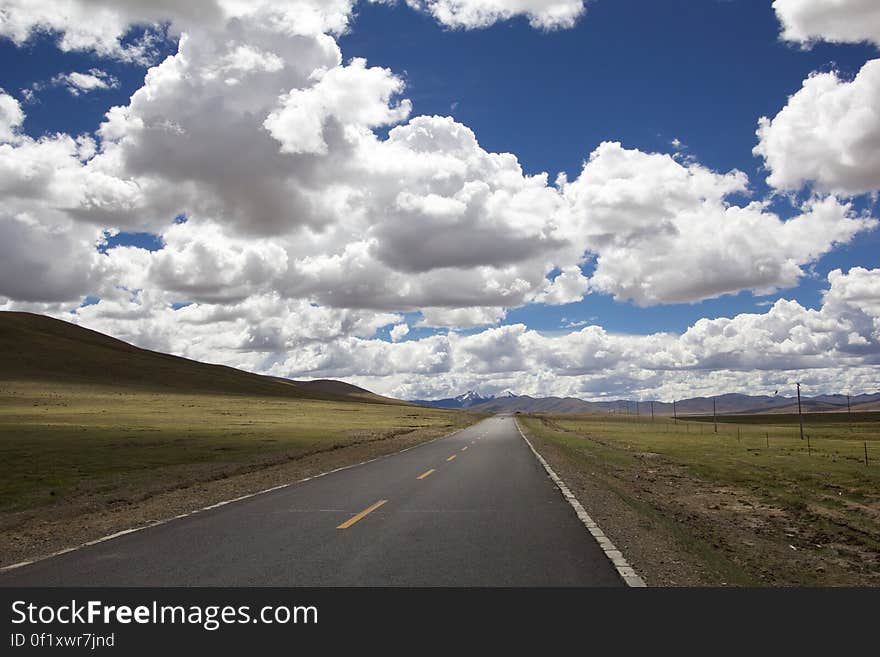 A road passing through green fields and farmlands. A road passing through green fields and farmlands.