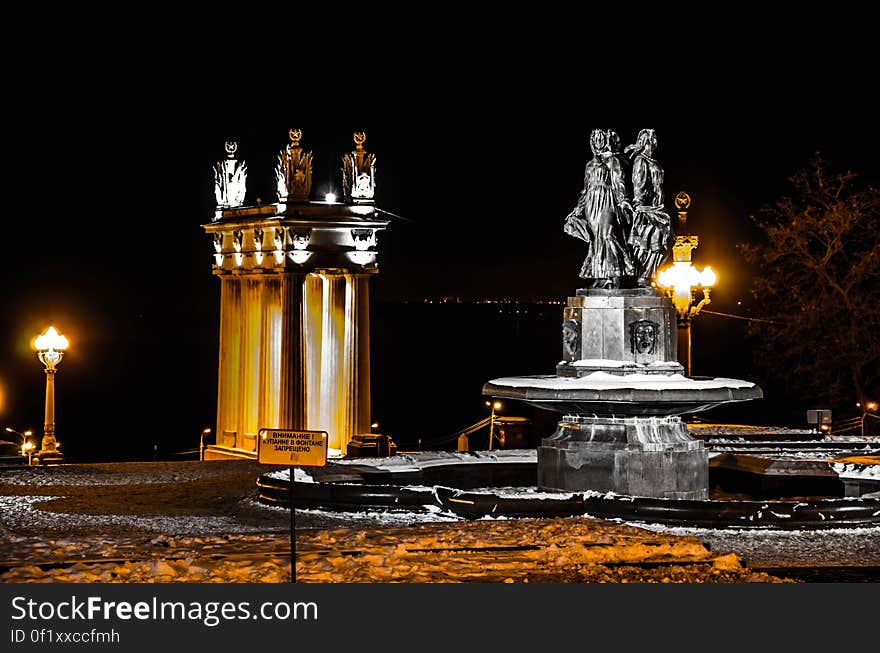 A fountain and a monument at night in the winter. A fountain and a monument at night in the winter.